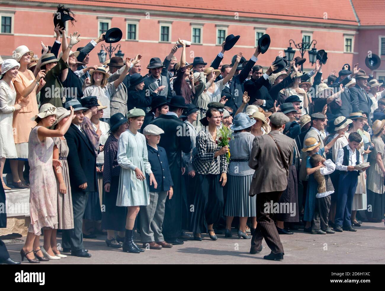 Film extras perform for a movie scene in Castle Square in the Old Town in Warsaw in Poland. Stock Photo