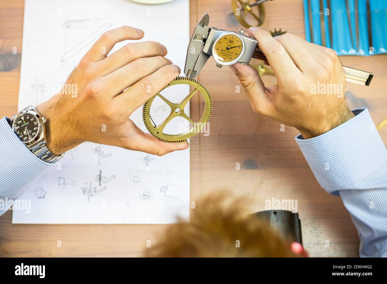 young man assembling mechanical watch. watch production. mans hands ...