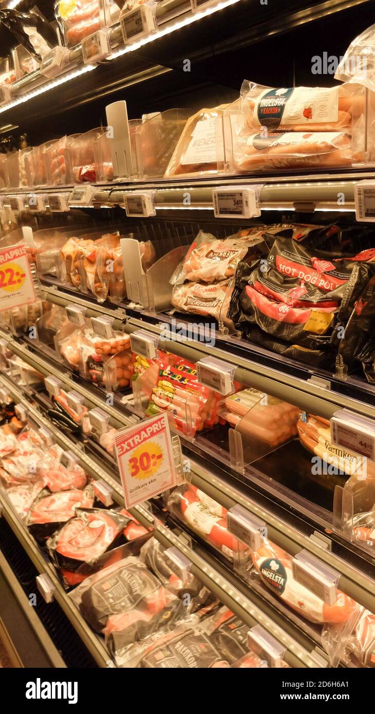 Meat in a fridge shelf at a swedish supermarket : chicken, sausages, beef, salami… Stock Photo