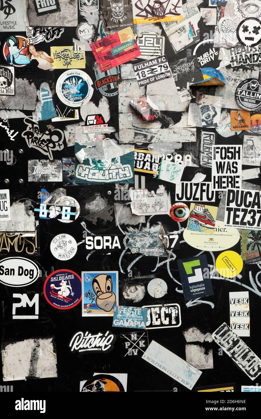 Stickers on black painted wall Stock Photo Alamy
