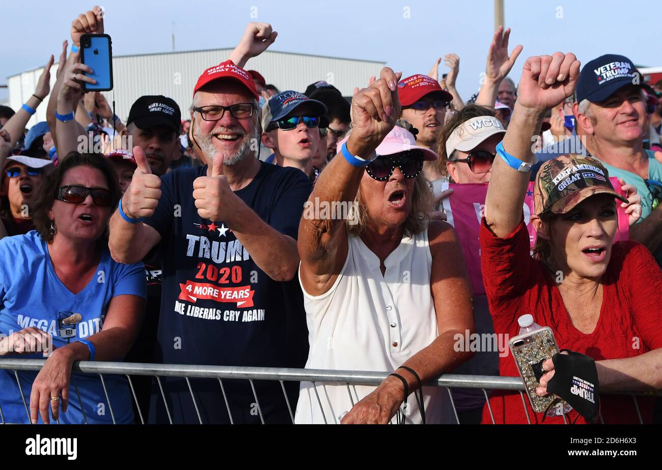 People chant slogans while making gestures during a campaign rally at Ocala International Airport.With 18 days until election day, President Trump holds rallies on an almost daily basis in his bid for re-election against Democratic presidential nominee Joe Biden. Stock Photo