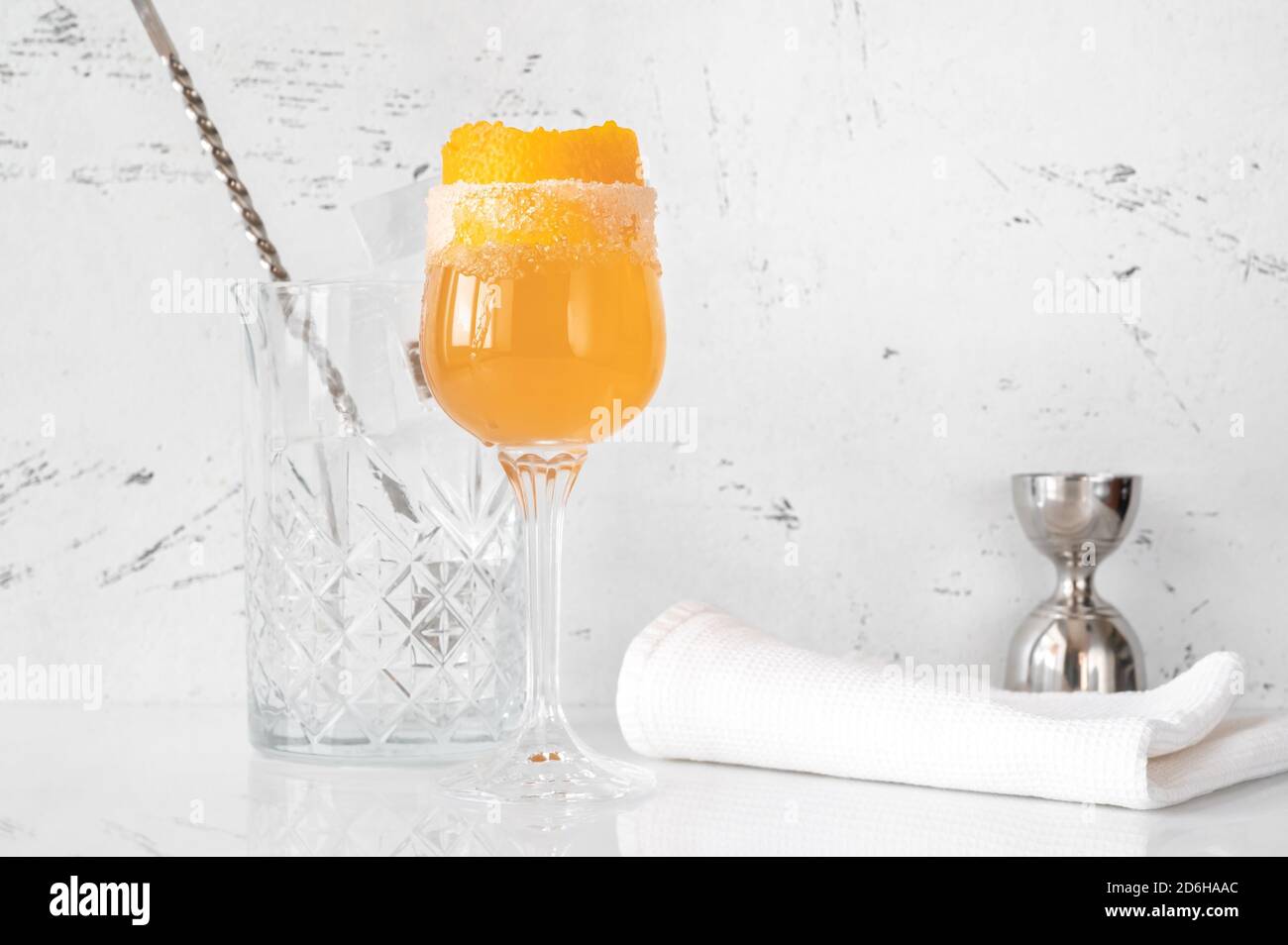 Glass of Brandy Crusta cocktail garnished with orange zest Stock Photo