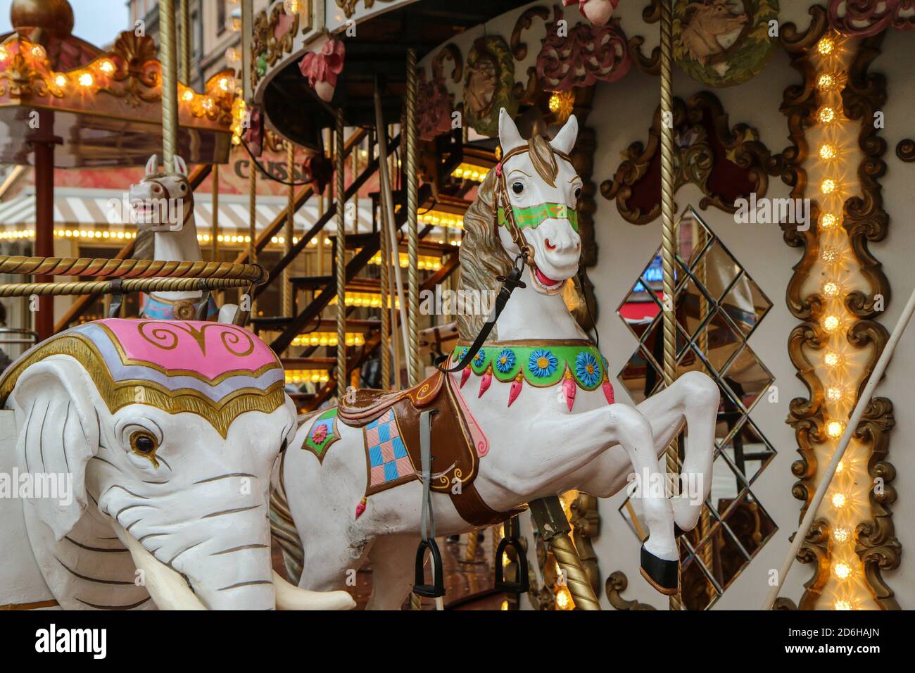 The detail of the smiling horse statue on the old carousel. Stock Photo