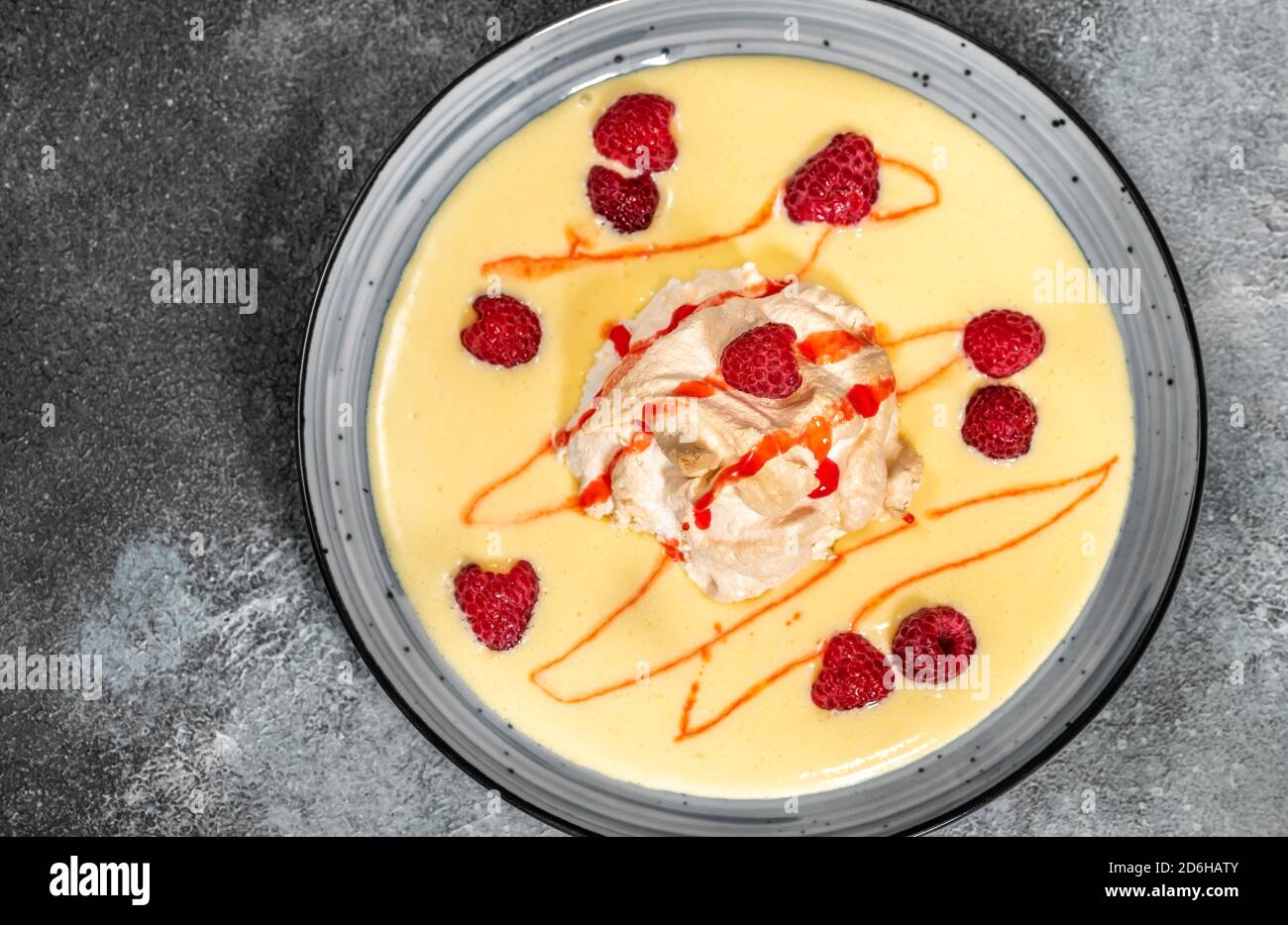 Floating island dessert made of meringue floating on vanilla custard