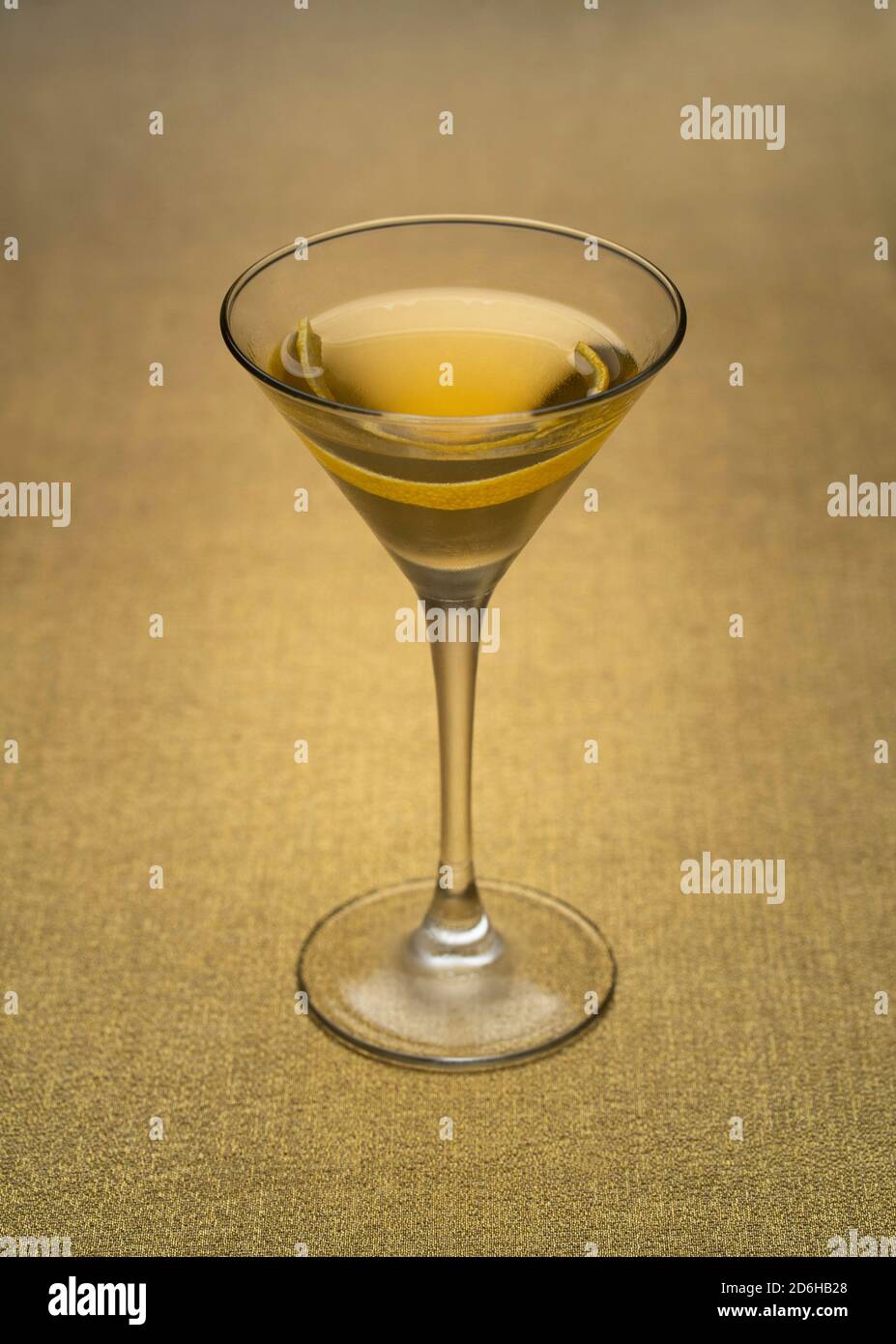 vodka martini with lemon twist indoors on golden fabric Stock Photo Alamy