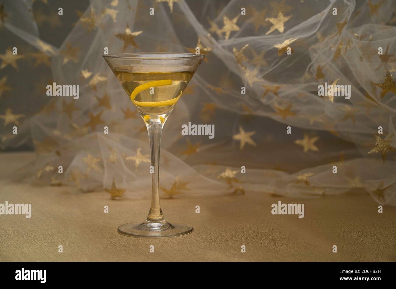 vodka martini with lemon twist indoors on golden fabric Stock Photo Alamy
