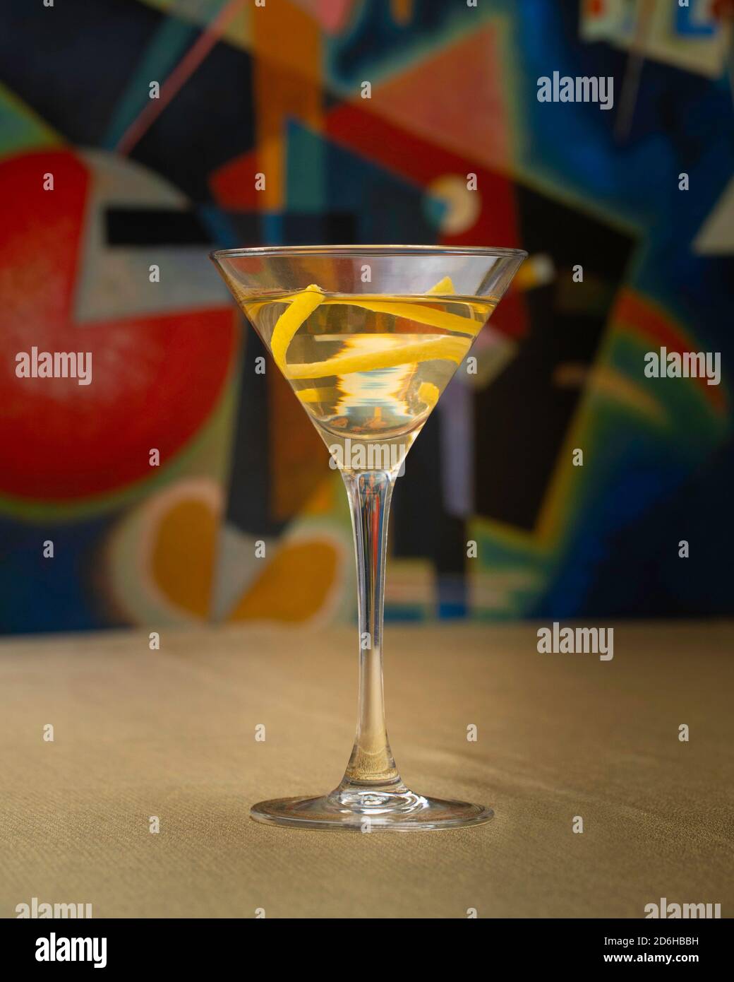 Vodka Martini cocktail with lemon twist on golden cloth in front of Kandinsky artwork Stock Photo
