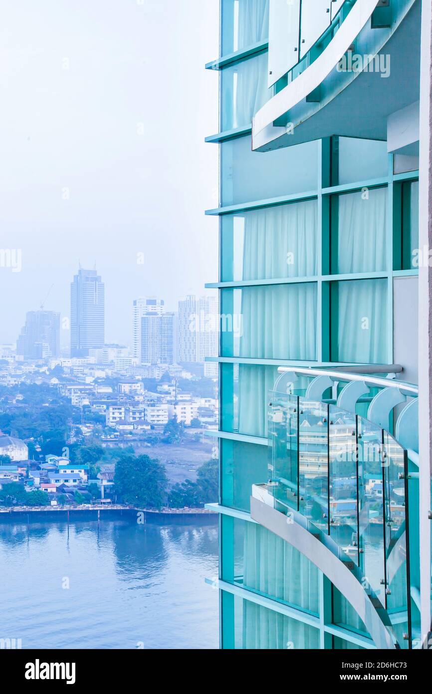 Bangkok skyline and Chao Phraya River in the morning, wideness view from balcony of room on high-rise modern glass residential building. Stock Photo