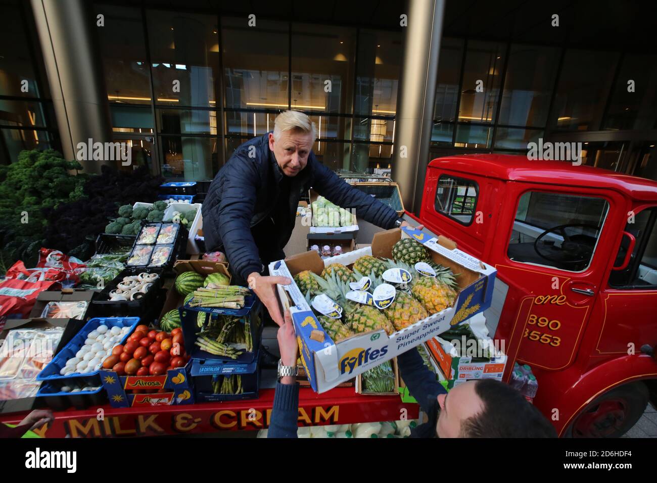 16OCT 2020: BELFAST, CO.ANTRIM: Brian Townley hands out boxs of fresh produce which was being sold either as a donation or below 50% of normal price outside a Belfast Hotel as Northern Ireland prepares to lock down as from 18:00 BST on Friday as Northern Ireland is put under stricter Covid-19 restrictions.On Thursday the Finance Minister Conor Murphy announced hotels will be able to apply to a scheme designed to help businesses forced to shut. The additional financial support comes after new restrictions were announced in a bid to stem cases of Covid-19. Photo/Paul McErlane Stock Photo