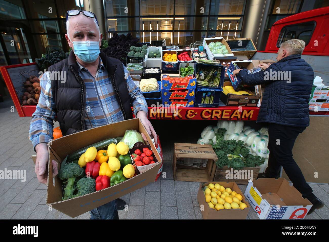 16OCT 2020: BELFAST, CO.ANTRIM: Local pumber Ian Adair buys a box of fresh produce which was being sold either as a donation or below 50% of normal price outside a Belfast Hotel as Northern Ireland prepares to lock down as from 18:00 BST on Friday as Northern Ireland is put under stricter Covid-19 restrictions.On Thursday the Finance Minister Conor Murphy announced hotels will be able to apply to a scheme designed to help businesses forced to shut. The additional financial support comes after new restrictions were announced in a bid to stem cases of Covid-19. Photo/Paul McErlane Stock Photo
