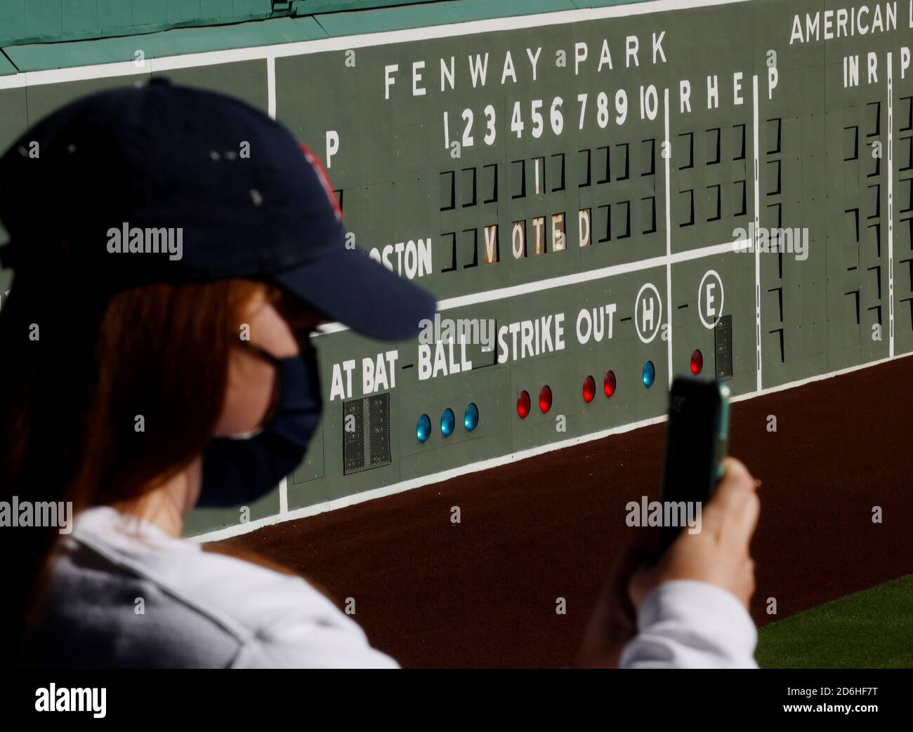 A voter takes a selfie after casting her ballot at Fenway Park on the first day of early voting in Boston, Massachusetts, U.S., October 17, 2020. REUTERS/Brian Snyder Stock Photo