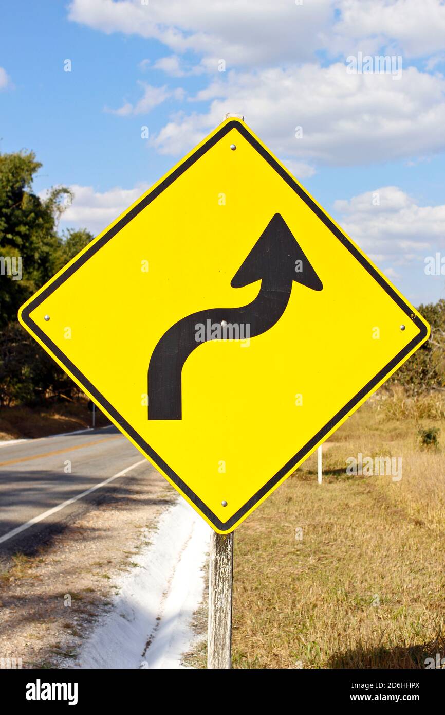 warning traffic sign sharp right curve Stock Photo