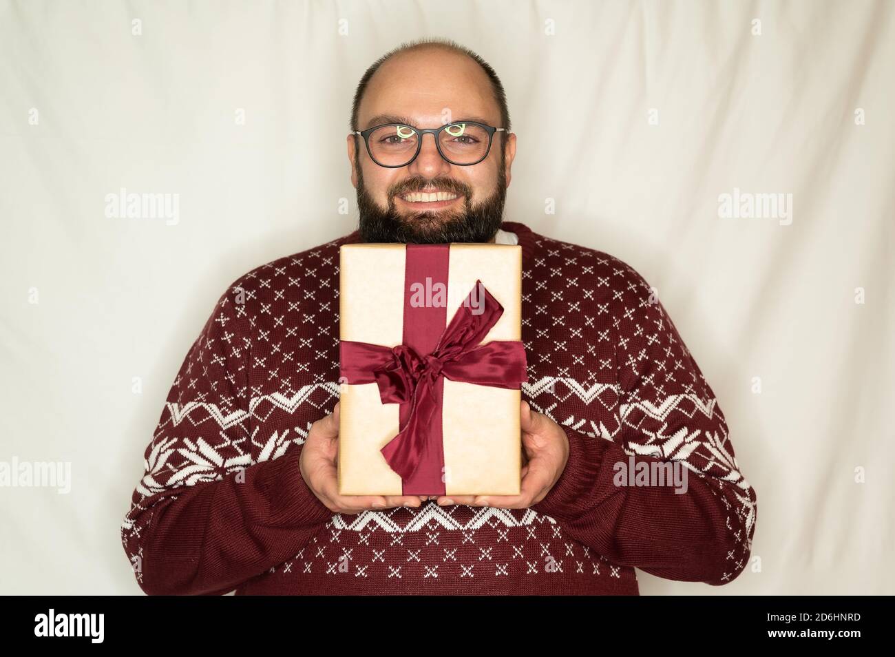 man is happy about a present and happily holds it in the camera Stock Photo