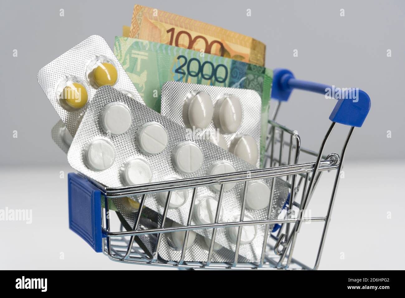 Paid medicine. To buy medicines. Tenge. Kazakhstan. Health system. Economy. Medications for treatment. Medical expenses, expensive treatment. Increase Stock Photo