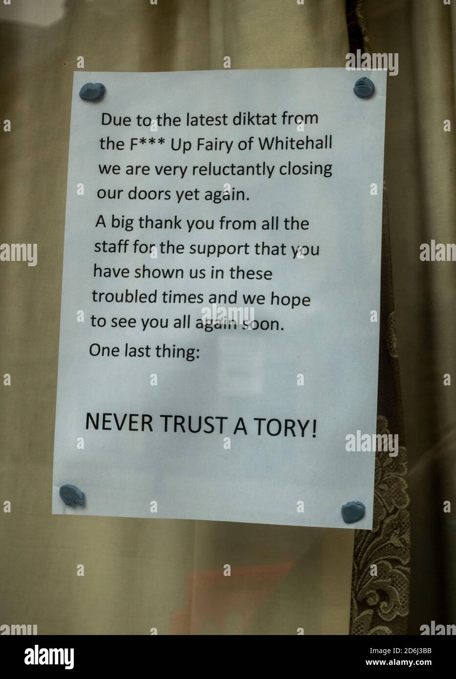 Sign in the window of The Lion Tavern in Liverpool shows the management unhappy with the latest 3 tier lockdown of pubs Stock Photo