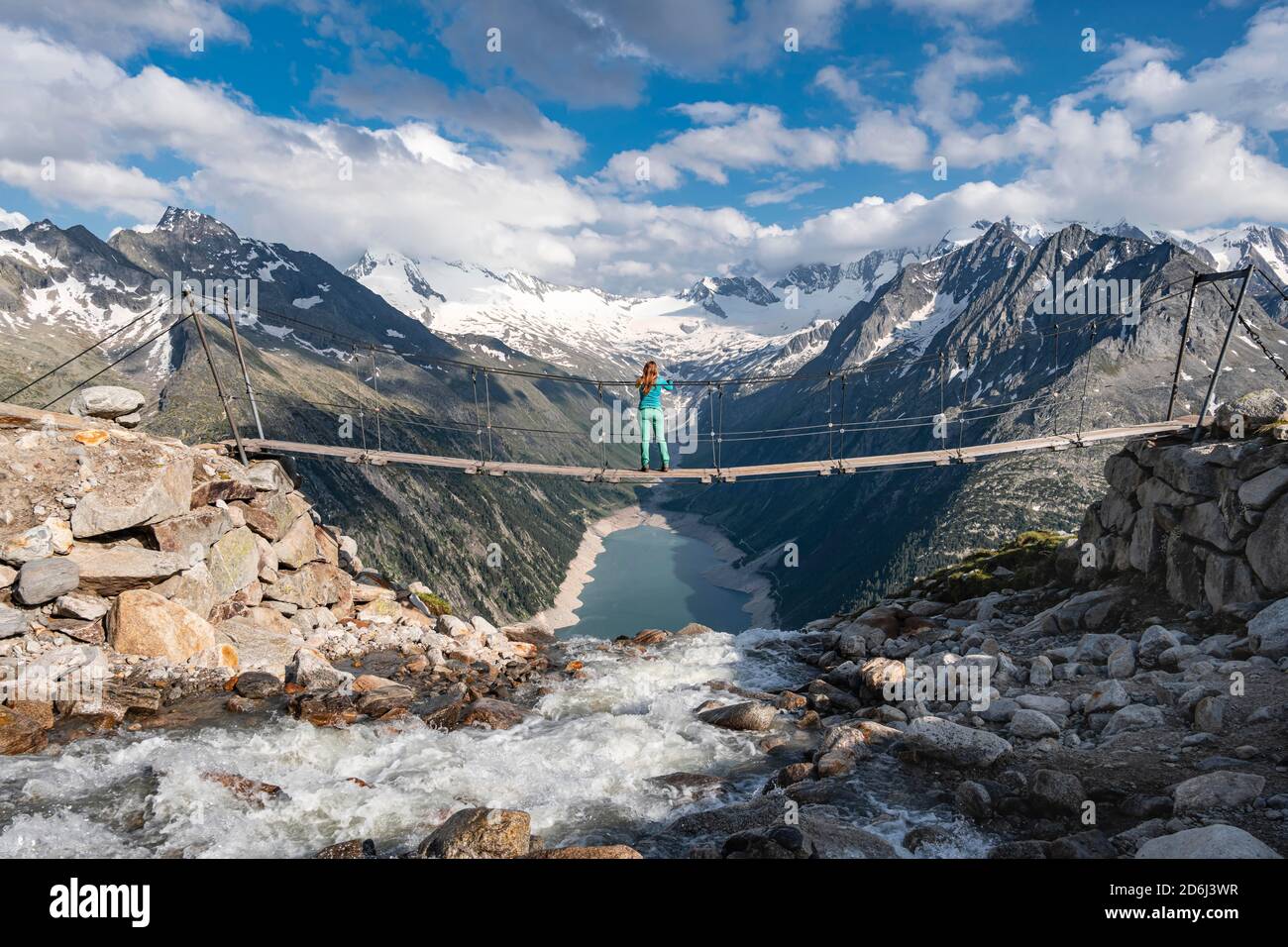Hiker, woman on suspension bridge at the Olpererhuette, Schlegeis