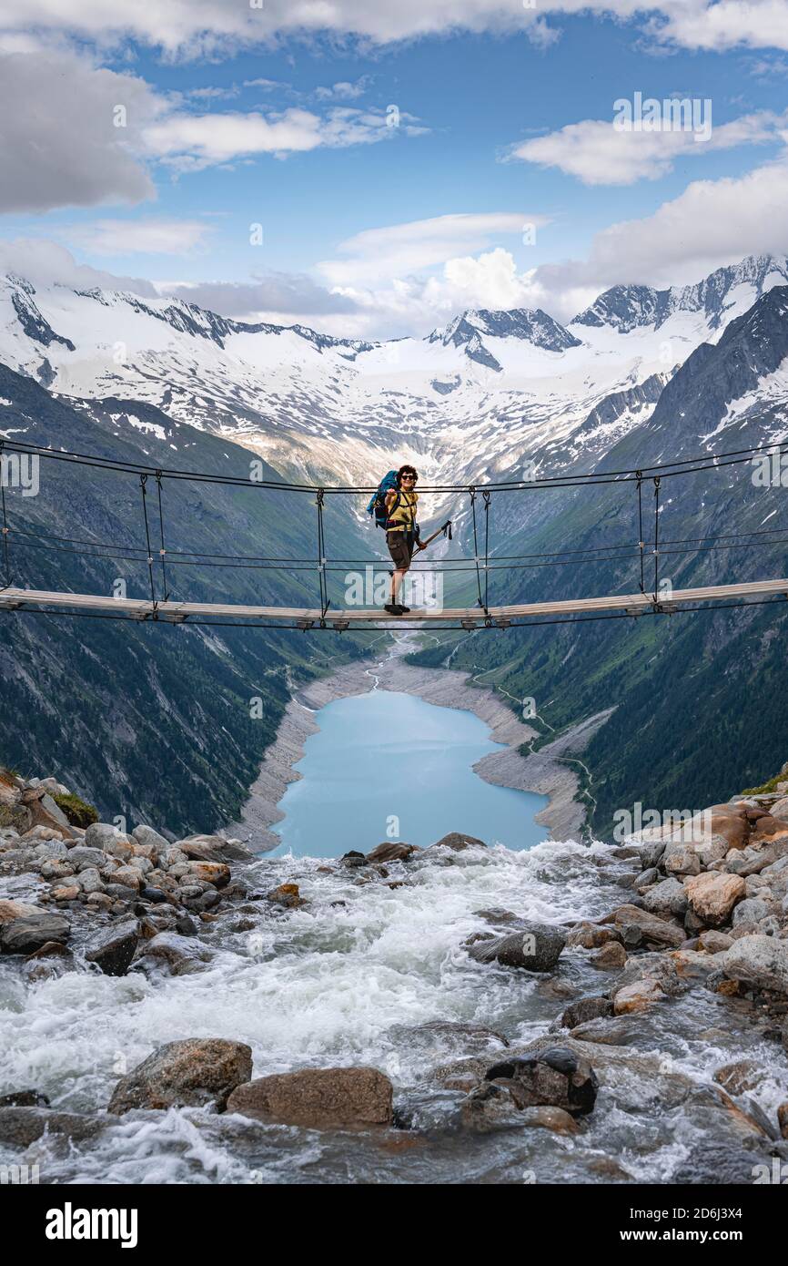 Hiker, woman on suspension bridge at the Olpererhuette, Schlegeis