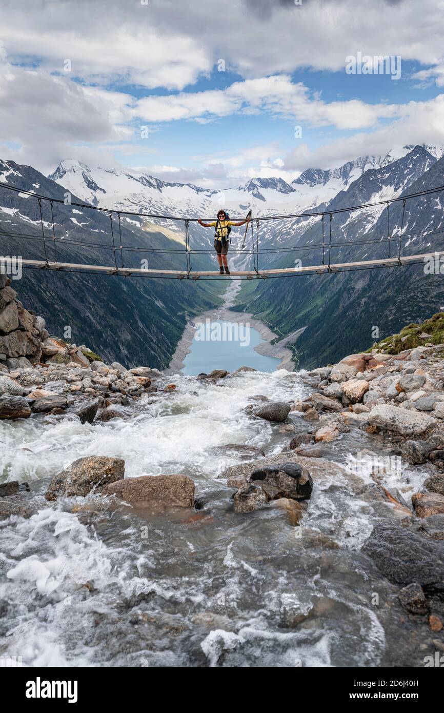 Hiker, woman on suspension bridge at the Olpererhuette, Schlegeis