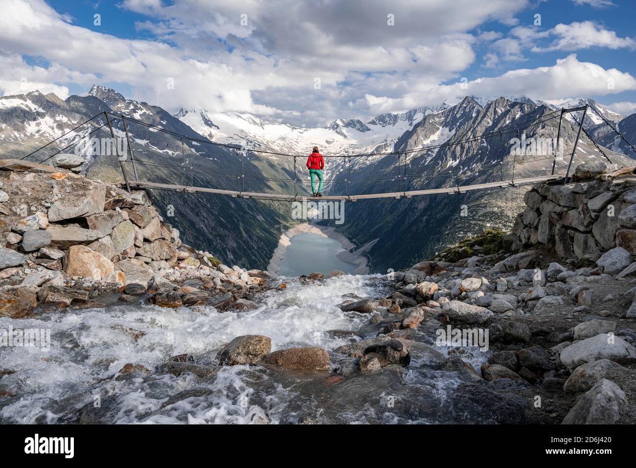 Hiker, woman on suspension bridge at the Olpererhuette, Schlegeis