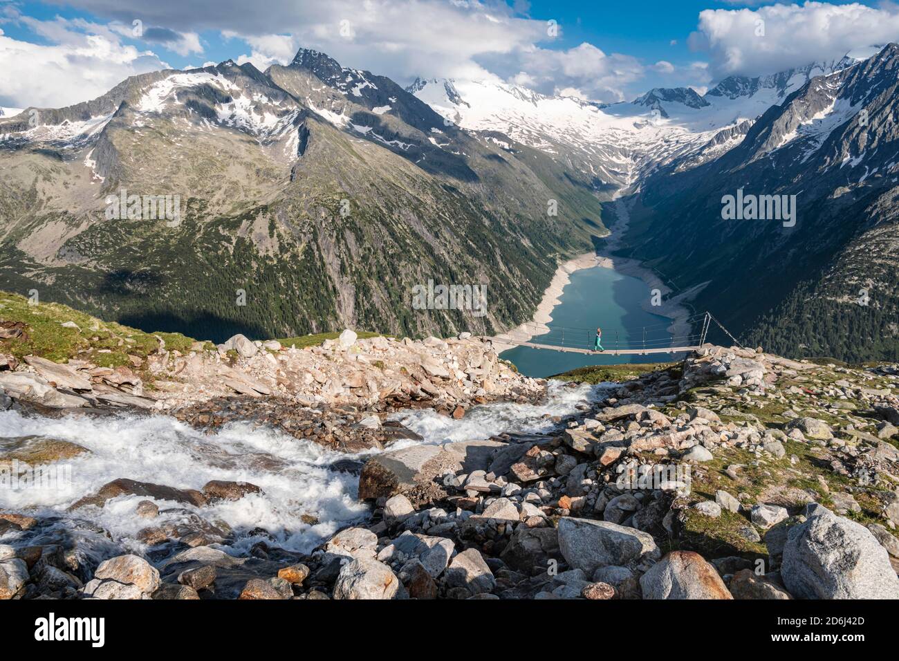 Hiker, woman on suspension bridge at the Olpererhuette, Schlegeis