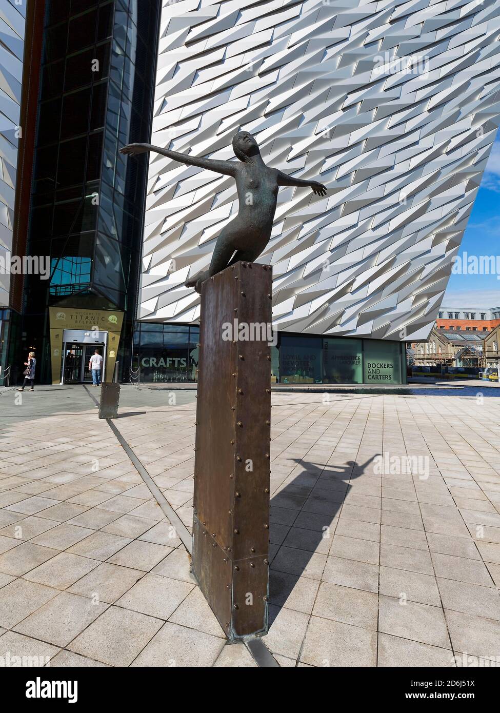 Sculpture Titanica, bronze female figure spreading her arms, sculptor Rowan Gillespie, Titanic Belfast Visitor Centre and Museum, Titanic Quarter Stock Photo