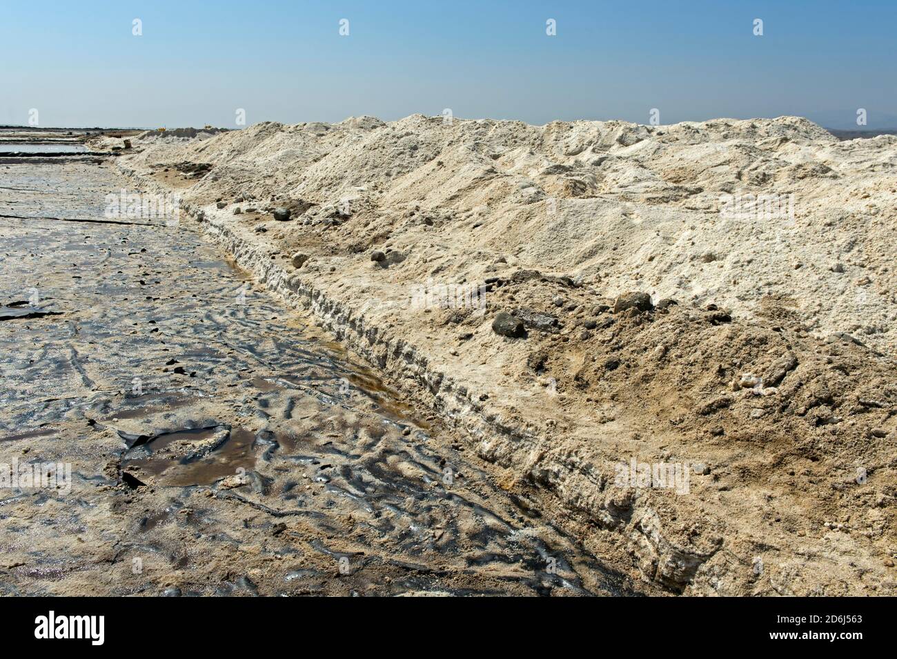 Harvested rock salt at the edge of an evaporation basin of a salt works, commercial salt