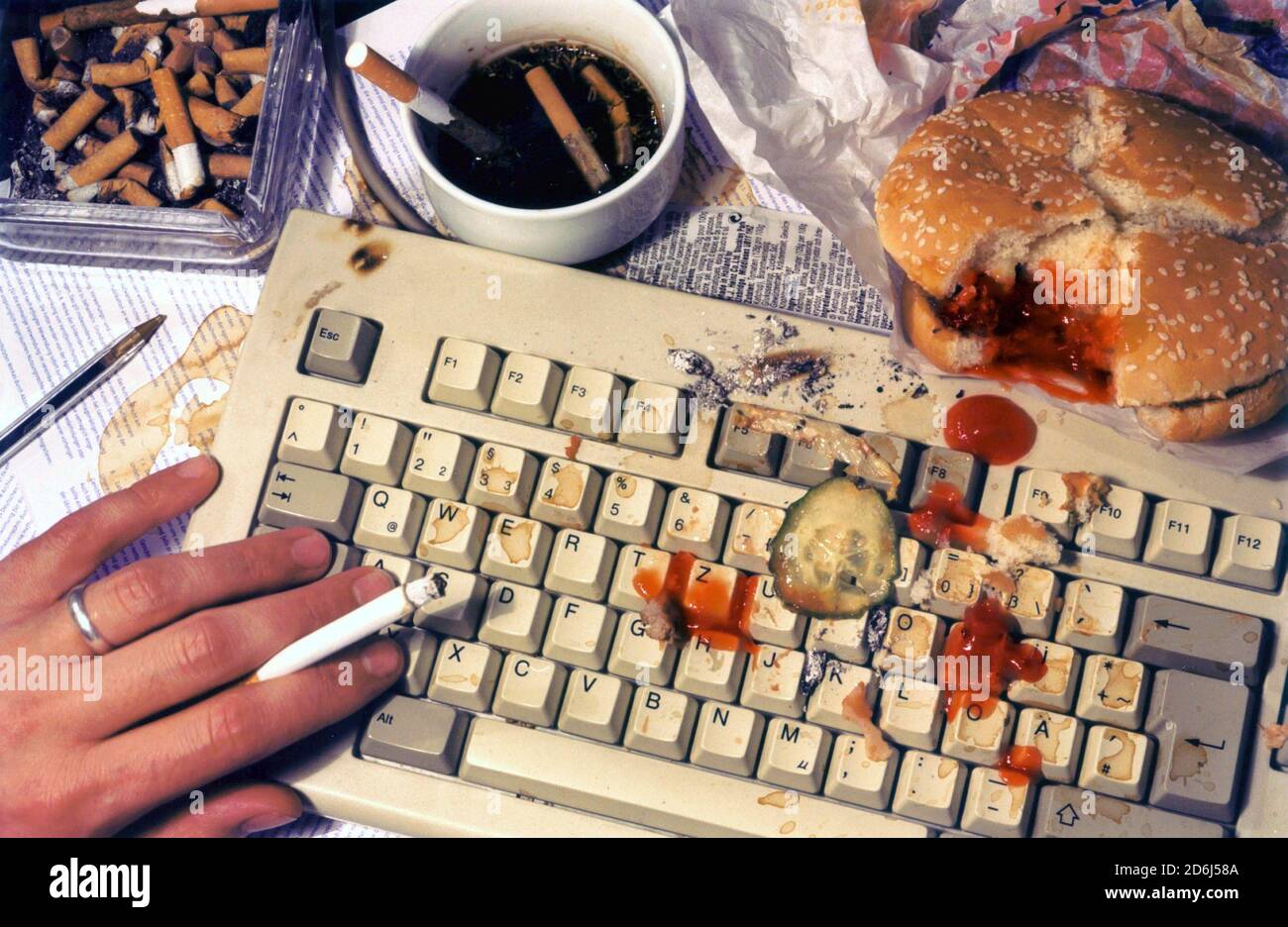 Nerd, man is hamburger on computer, cigarette, keyboard, disgusting, dirt,  Berlin, Germany Stock Photo - Alamy