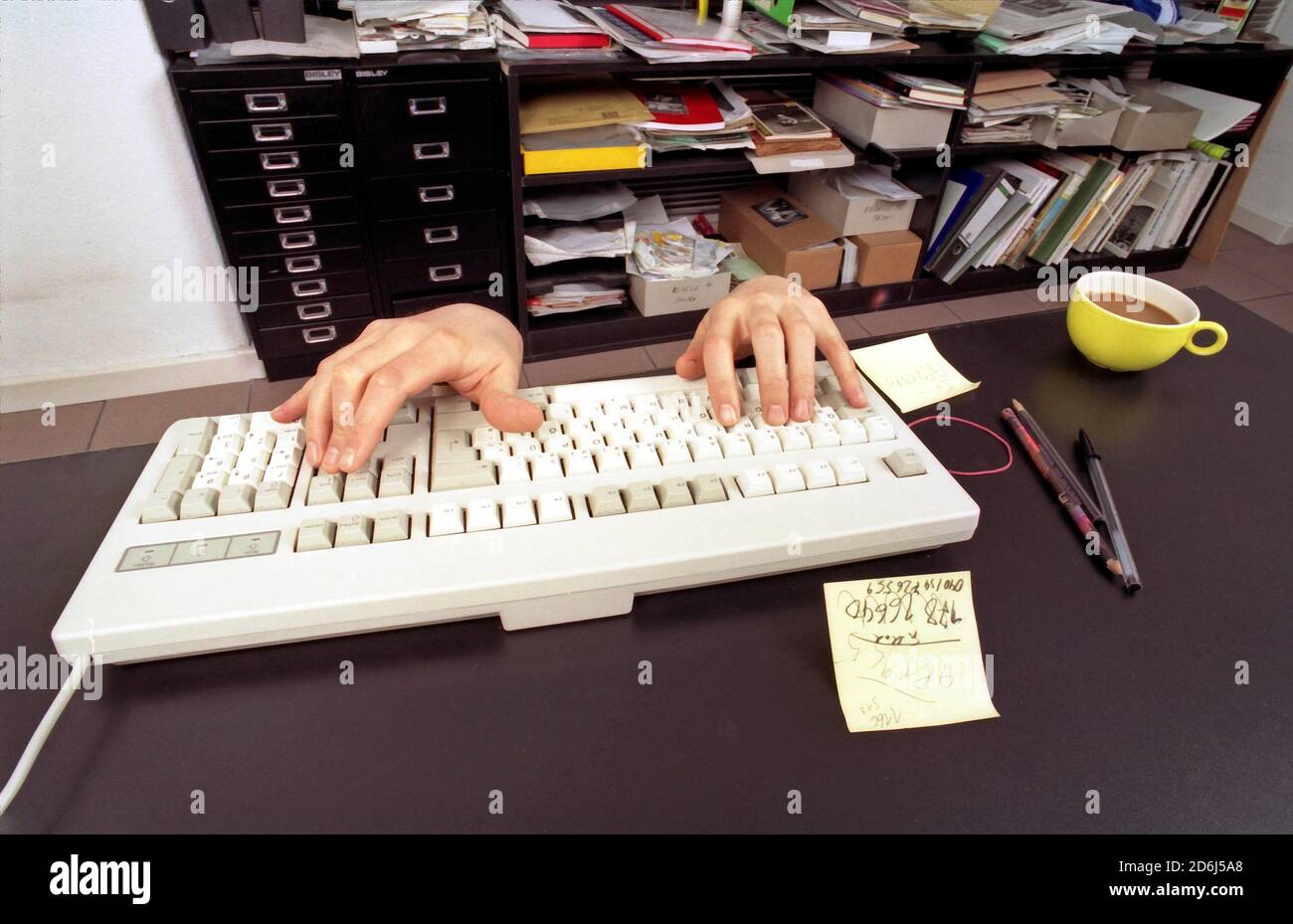 Strange, two typing hands, keyboard, Berlin, Germany Stock Photo