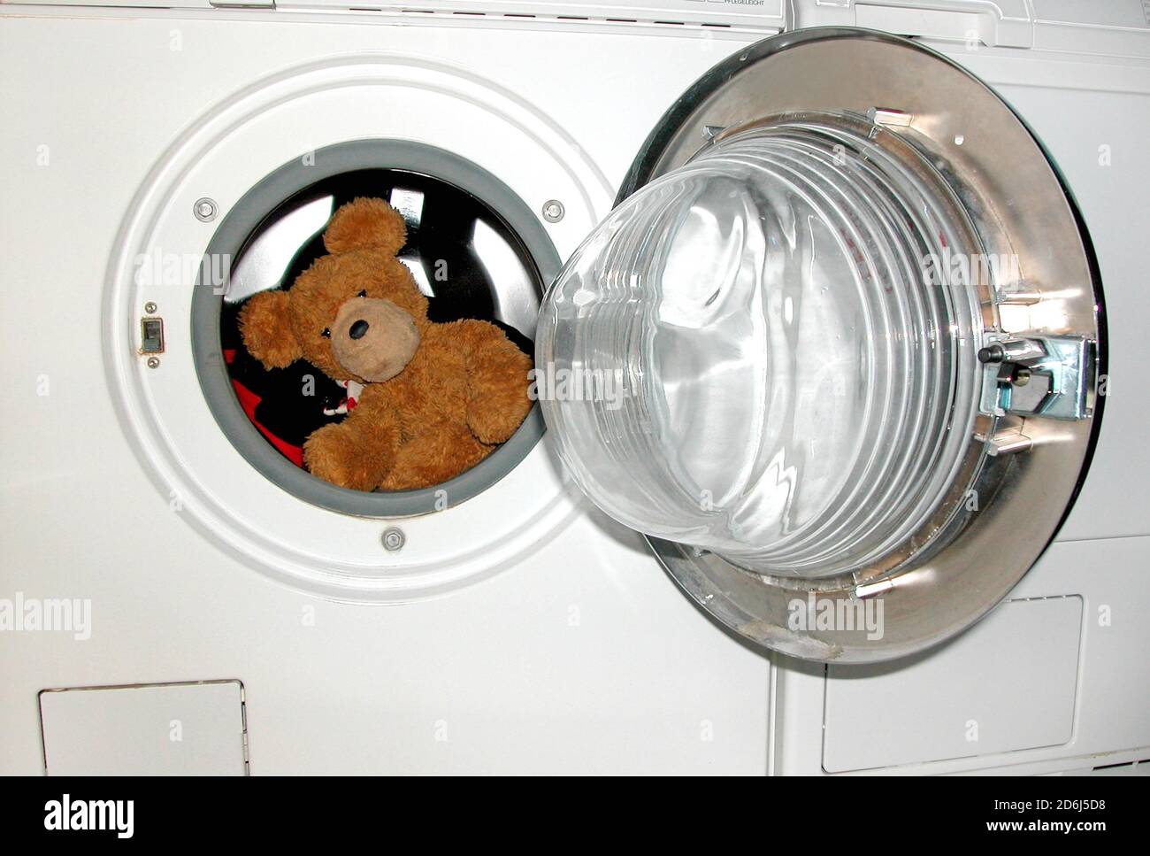 Soft toy teddy bear in the washing machine Berlin Germany Stock