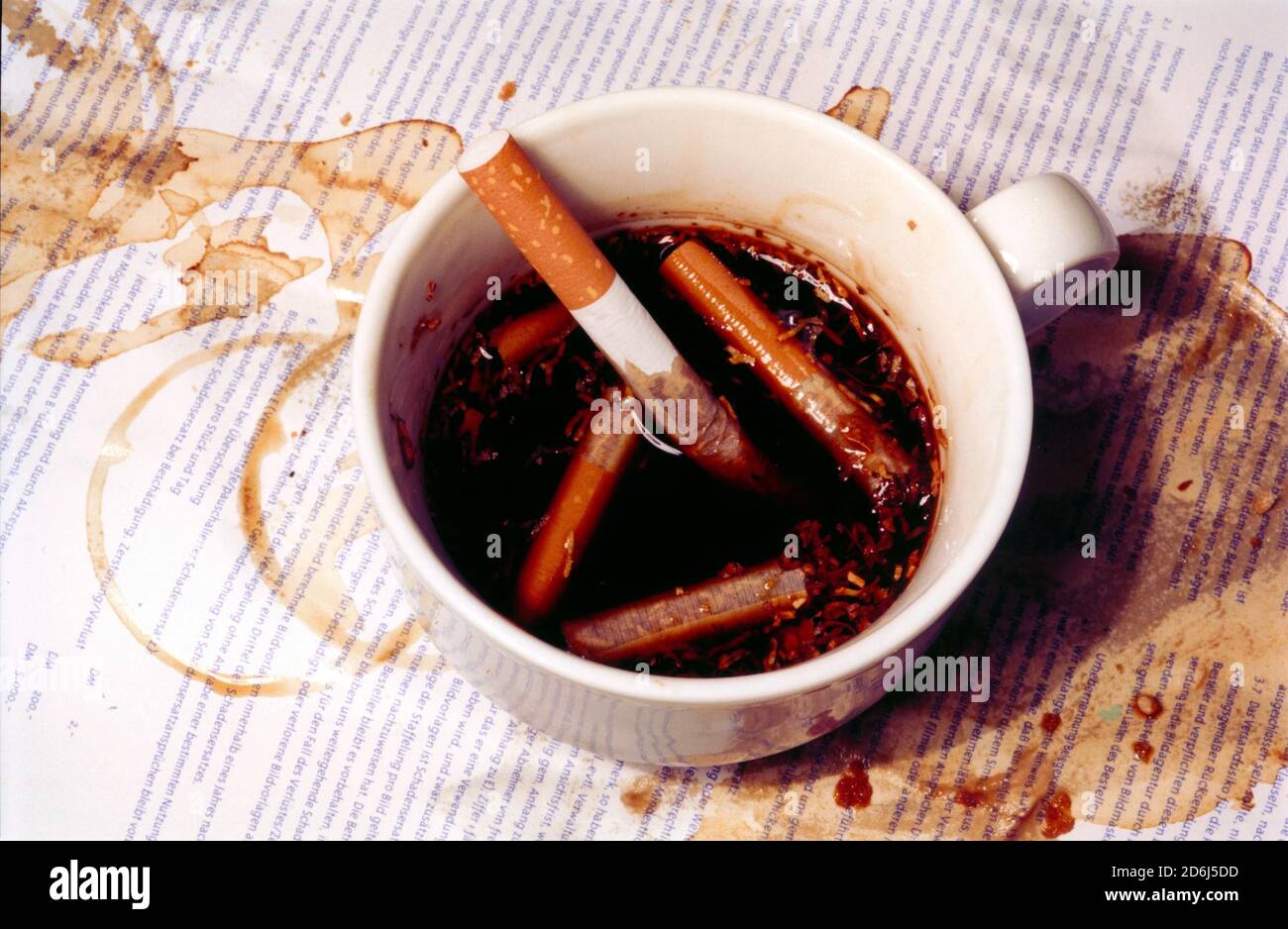 Cigarettes in a coffee cup, disgusting, ashtray, Berlin, Germany Stock  Photo
