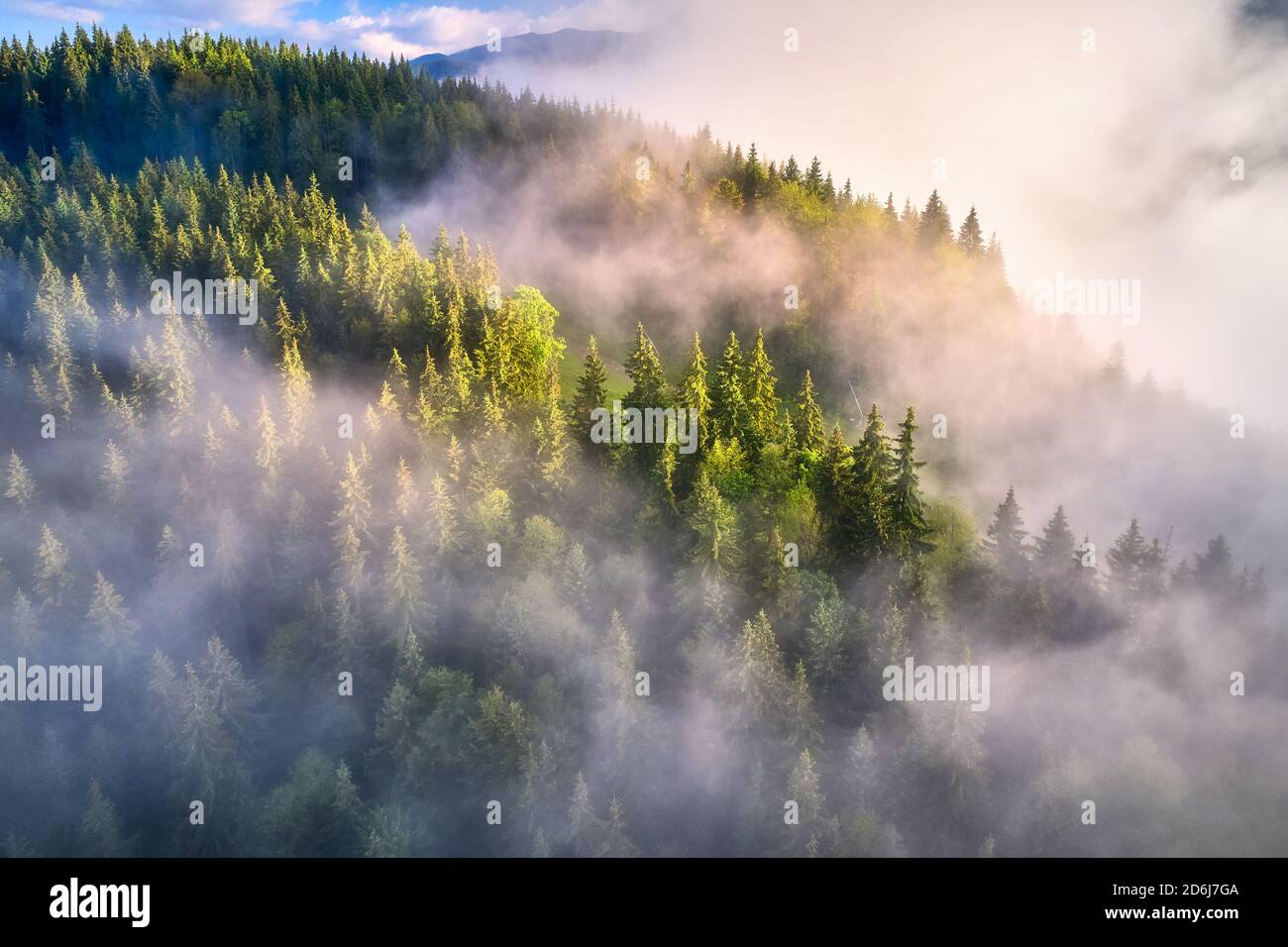 Mountains in clouds at sunrise in summer. Aerial view Stock Photo - Alamy