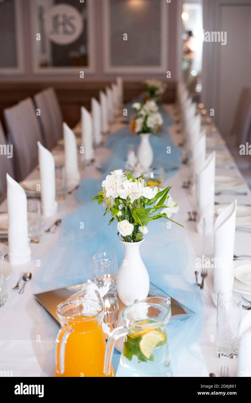 A table set during the First Holy Communion reception at a reception venue in Poland, during a warm and sunny Spring day Stock Photo