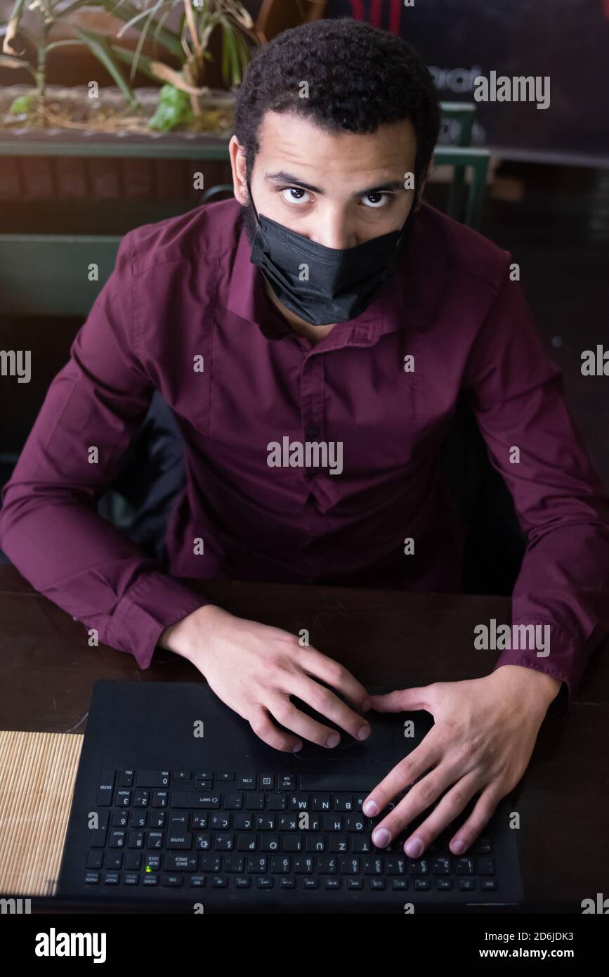 African businessman or developer wearing surgical face mask in the ...