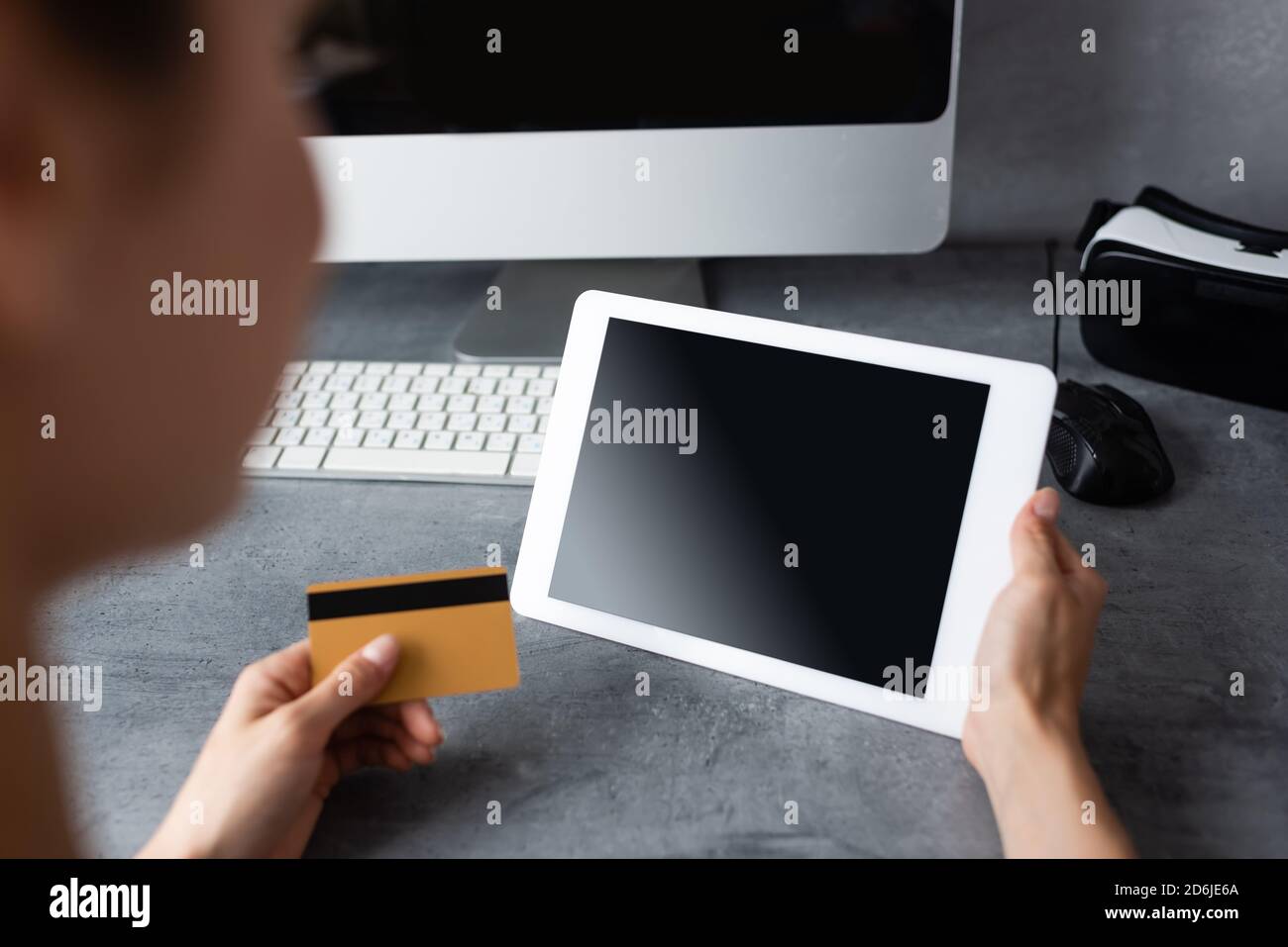 Tele Computer Onb Computer Selective focus of teleworker using digital tablet and credit card near ...