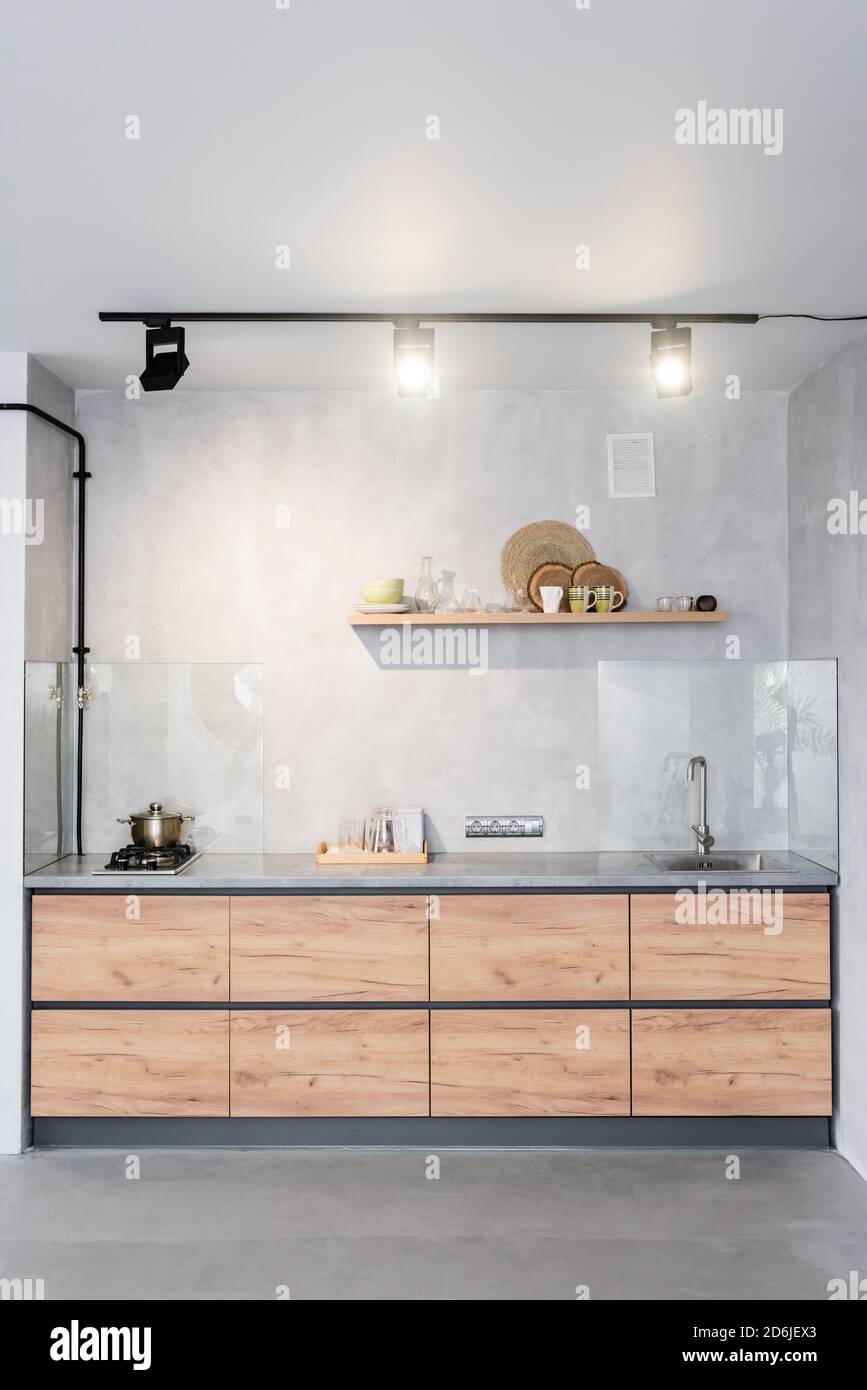 Spacious, minimalistic kitchen with concrete walls Stock Photo