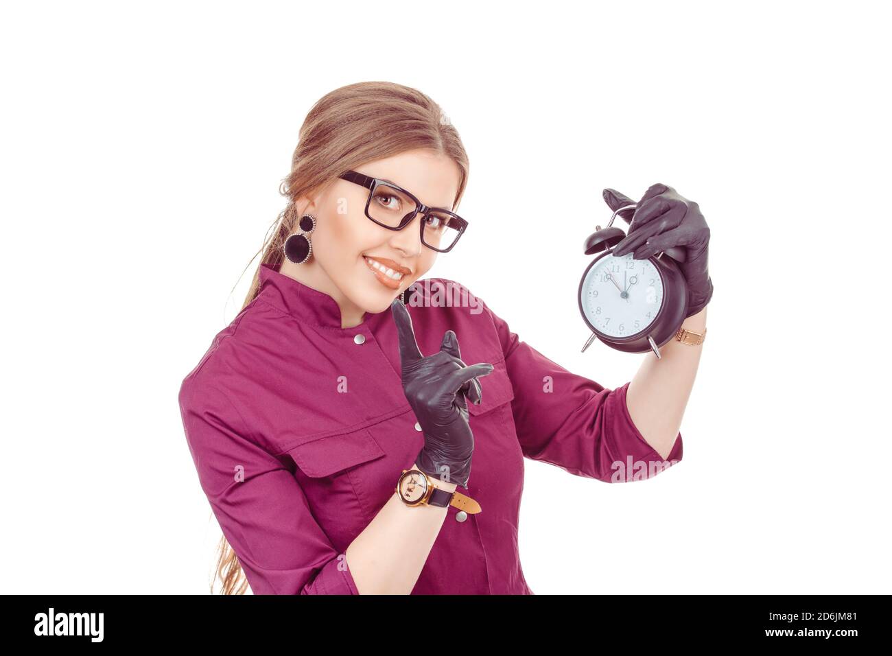 Beautiful girl with alarm clock in hand raises his index finger up