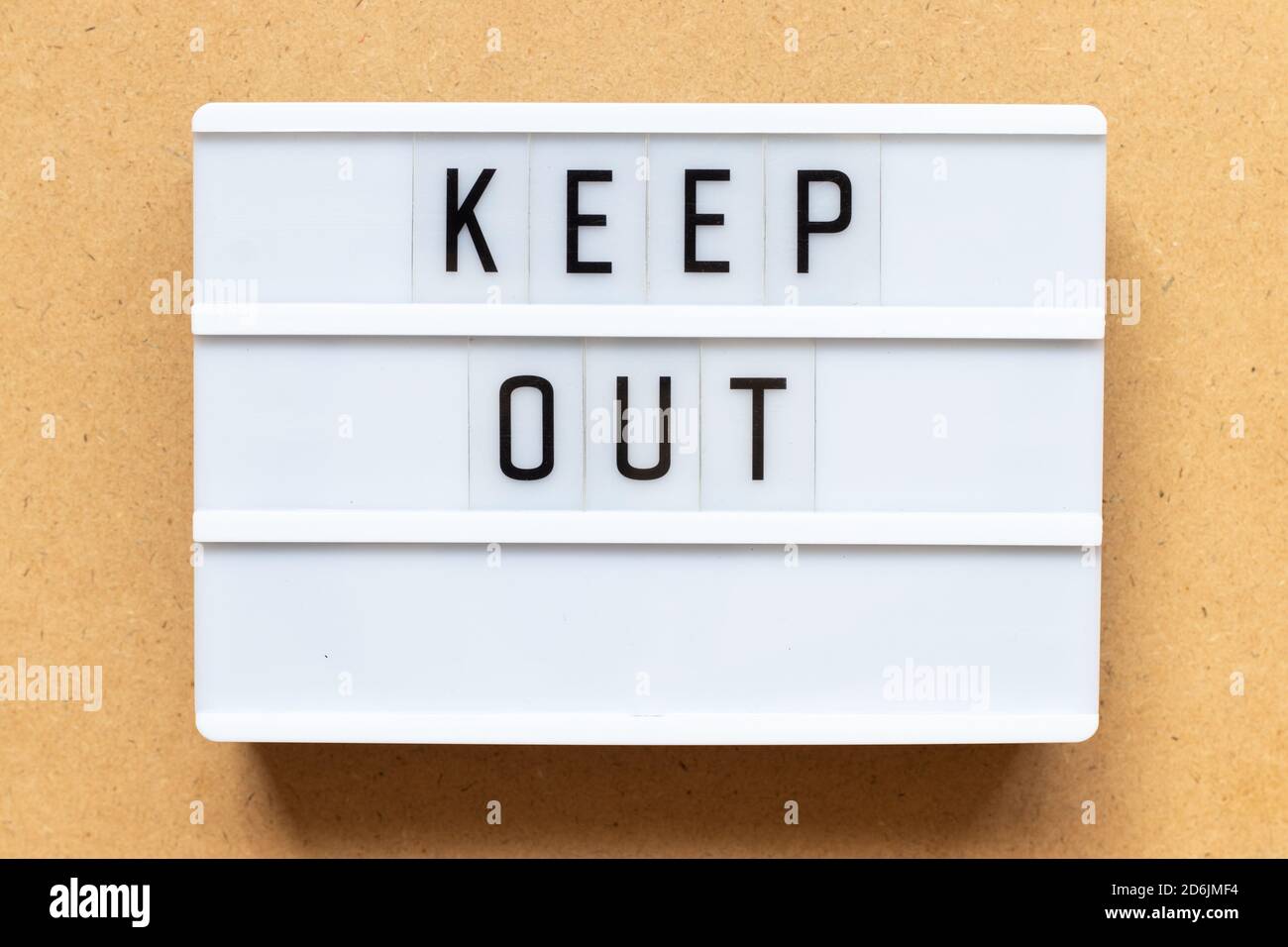 Lightbox with word keep out on wood background Stock Photo