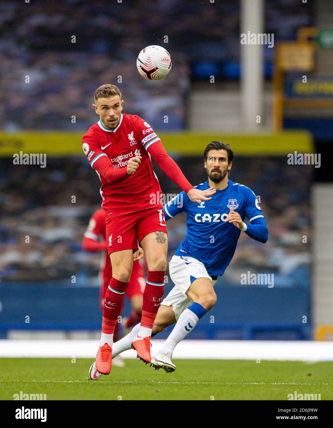 Liverpool. 18th Oct, 2020. Liverpool's captain Jordan Henderson (L) vies with Everton's Andre Gomes during the Premier League match between Everton FC and Liverpool FC at Goodison Park in Liverpool, Britain, on Oct. 17, 2020. The game ended in a 2-2 draw. Credit: Xinhua/Alamy Live News Stock Photo