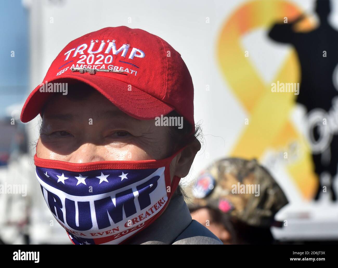 Dunmore, United States. 17th Oct, 2020. A supporter of President Donald Trump, wearing a hat and a face mask for Trump with a gun pin at the Road Scholar, Trucking company during the rally.Eric Trump speaks to approximately 400 people in Dunmore, PA, it's the city adjacent to Joe Biden's childhood home of Scranton. March of the audience was made up of a group called Japan 4 Donald Trump, as Eric Trump speaks of gun rights and Amy Coney Barrett. Credit: SOPA Images Limited/Alamy Live News Stock Photo