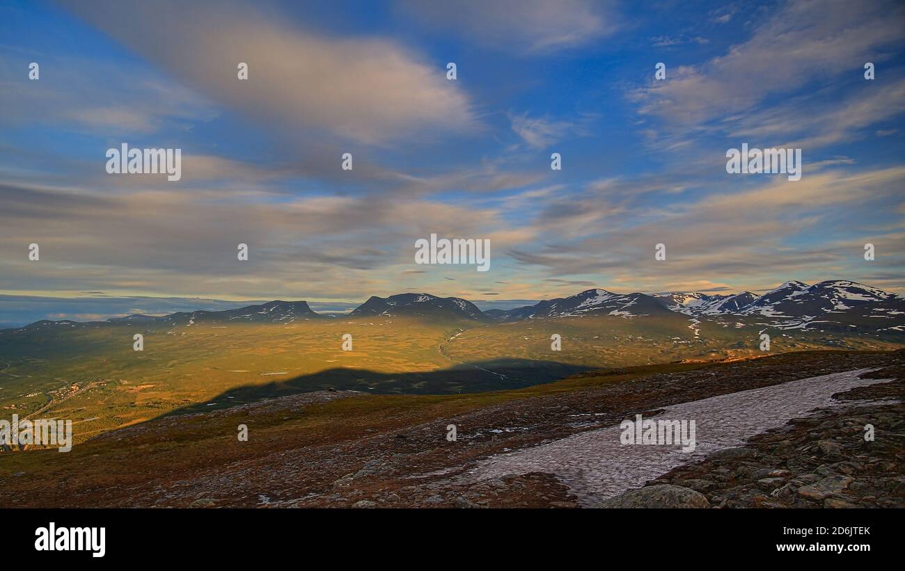 In summer nights here on Mount Nuolja, the mountain casts a shadow on Abisko valley. Stock Photo