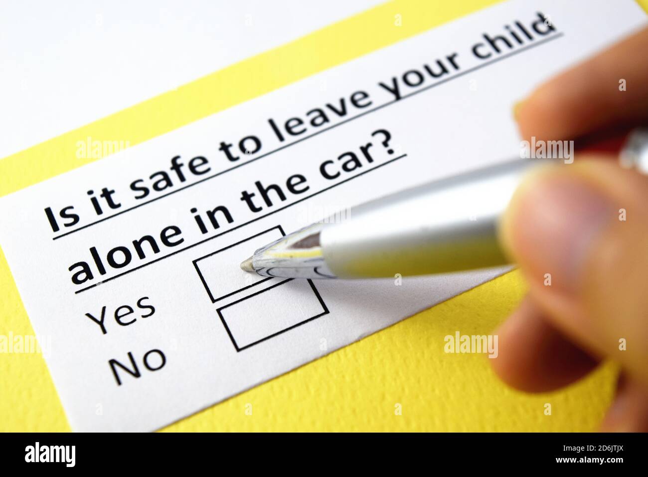 Is it safe to leave your child alone in the car? Yes or no Stock Photo