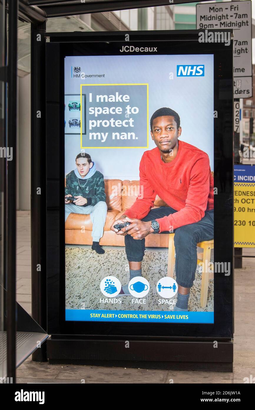 London, UK. 17th Oct, 2020. A NHS (National Health Service) sign seen on a Bus stop's electronic advertising screen with the Governments latest advice of ‘Hands Face and Space' as London has been moved to Tier 2 under the Governments new three-tier system. Credit: SOPA Images Limited/Alamy Live News Stock Photo