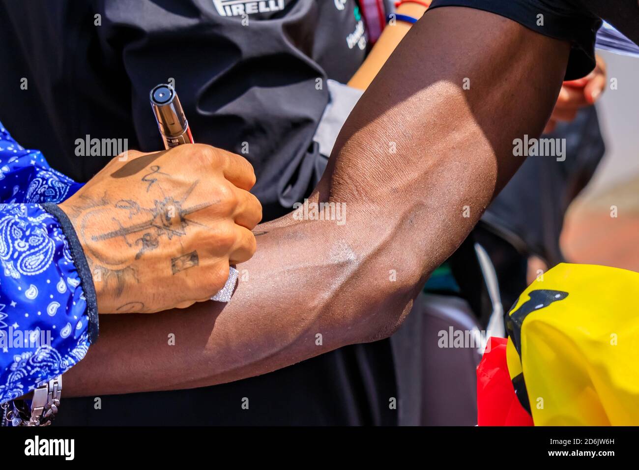 Monte Carlo, Monaco - May 24 2019: British racing driver Lewis Hamilton, 6 time Formula One World Champion signing a fan's arm at Monaco F1 Grand Prix Stock Photo