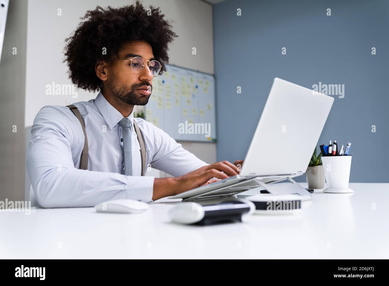 African American Business Man Using Laptop Computer In Office Stock Photo