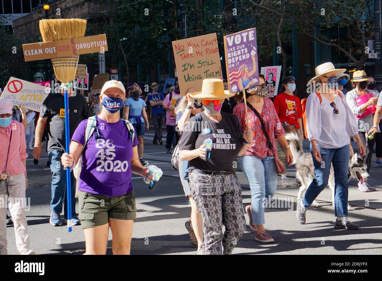 October 17, 2020. San Francisco Women's March before the USA Presidential Election. Protesters carry Vote, anti-Trump, and women's rights signs. Stock Photo