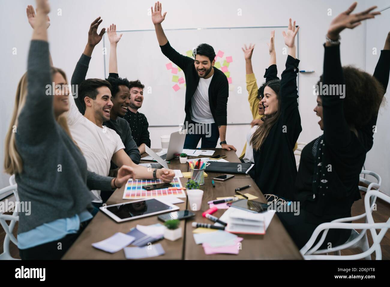 Happy business team celebrating with raised up hands in the office ...