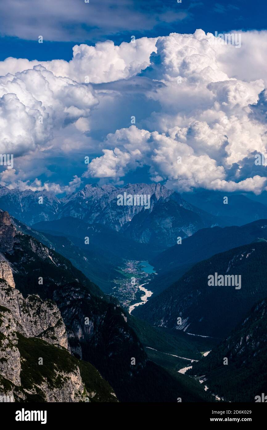 Aerial view on the Ansiei valley, Val d'Ansiei, the town Auronzo di Cadore and the lake Lago di Santa Caterina, thunderstorm clouds piling up. Stock Photo