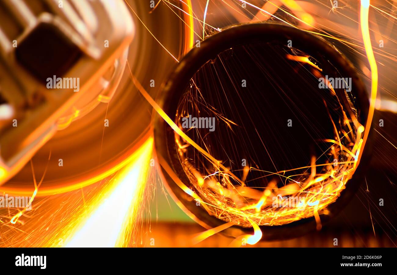 Cutting a metal pipe with angle grinder Stock Photo Alamy