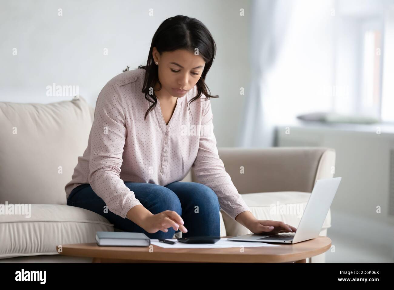 African American woman manage budget paying online Stock Photo