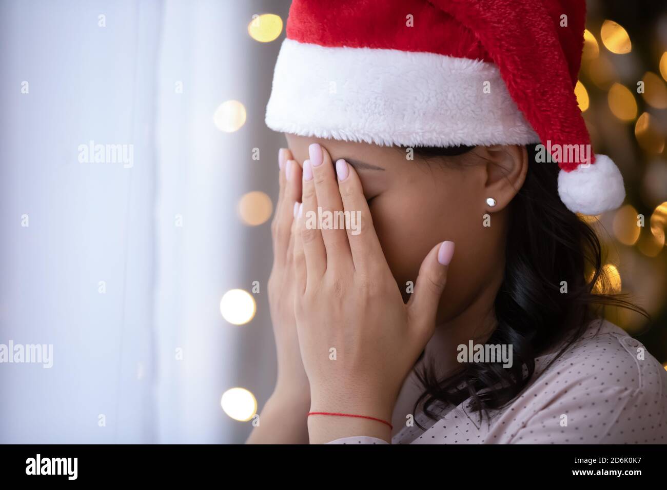 Depressed woman mourn celebrate Christmas alone at home Stock Photo